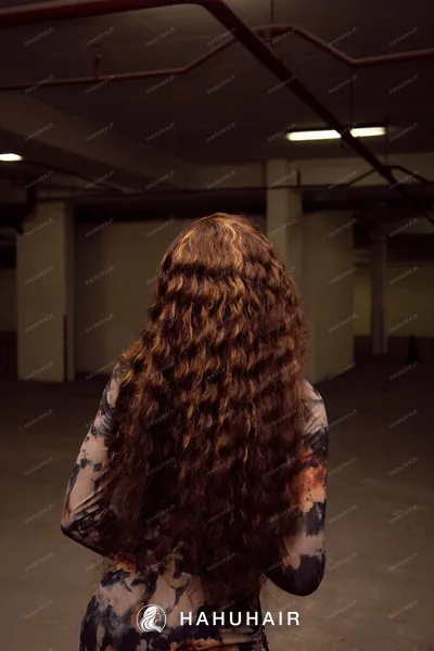 Long, tightly curled copper-brown hair seen from behind