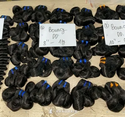 Bouncy curl black hair wefts laid out on a table